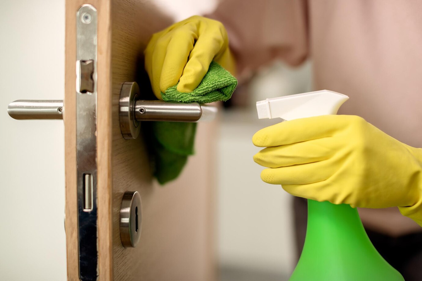 cloeup-woman-disinfecting-door-handle-home_637285-8522